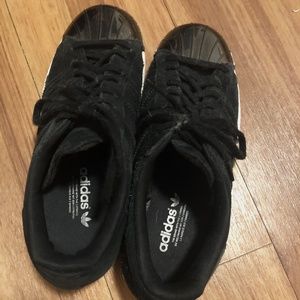 black adidas superstars with silver detailing